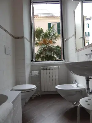 a bathroom with a sink and a toilet and a window at Red Flat In Rome in Rome