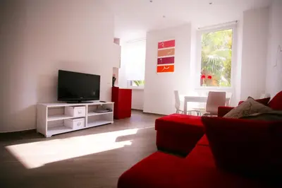 a living room with a tv and a red couch at Red Flat In Rome in Rome