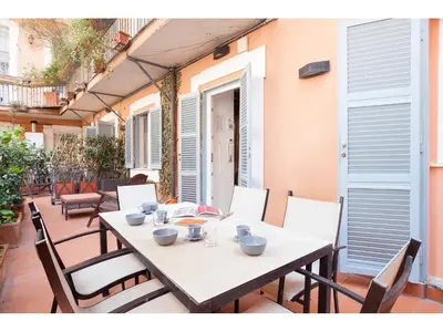 a white table and chairs on a patio at Apartment Via Farina in Rome