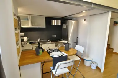 a small kitchen with a table and chairs in it at St. Peter Loft in Rome
