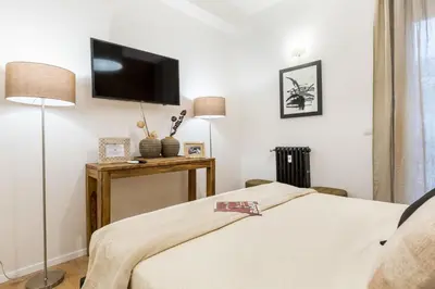 a bedroom with a bed and a flat screen tv at Thebestinrome Vite in Rome