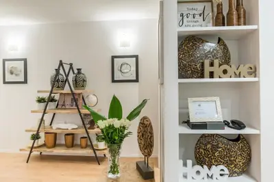 a room with shelves with a laptop and a vase of flowers at Thebestinrome Vite in Rome