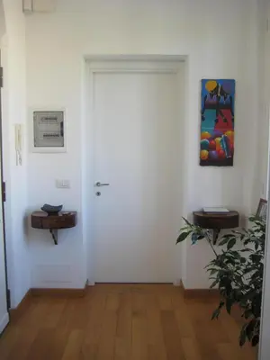 a white door in a room with a plant at The Queen in Rome