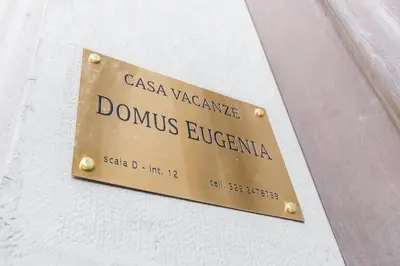 a sign on the side of a building at Domus Eugenia in Rome