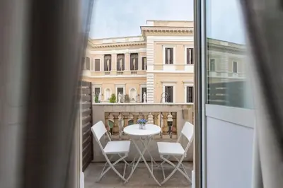 a balcony with a table and chairs and a building at Vanity Navona in Rome