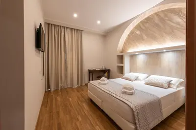 a bedroom with a large white bed in a room at Top Floor Colosseo Guesthouse in Rome