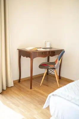 a wooden desk with a chair in a room at Top Floor Colosseo Guesthouse in Rome