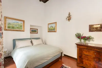 a bedroom with a bed and a wooden dresser at Annemary Maison in Rome