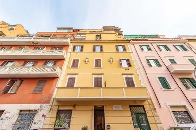 a yellow building in front of some other buildings at BHM Urban House Pigneto in Rome