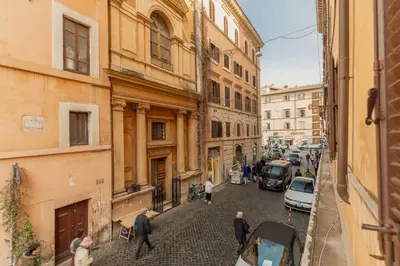 a group of people walking down a street with buildings at Campo de Fiori Bright Loft in Rome