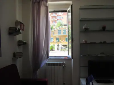 a window in a room with a radiator and a window at A.B Battistini Short Let's in Rome