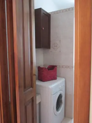 a bathroom with a washing machine and a washer at A.B Battistini Short Let's in Rome