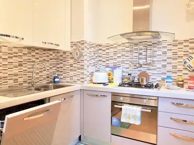 a kitchen with a sink and a stove top oven at Vatican Area Flat in Rome