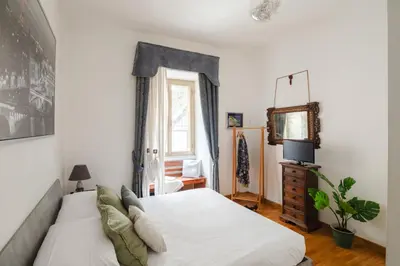 a bedroom with a white bed and a mirror at B&B Ibiscus in Rome
