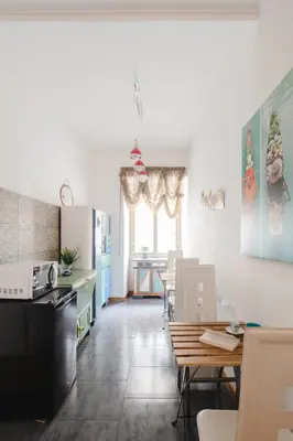 a kitchen and dining room with a table and chairs at B&B Ibiscus in Rome