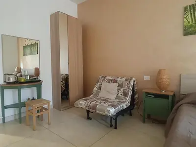 a living room with a couch and a chair at Coffee And The City in Rome