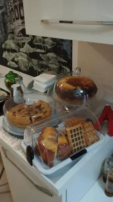 a table topped with different types of bread and waffles at Coffee And The City in Rome