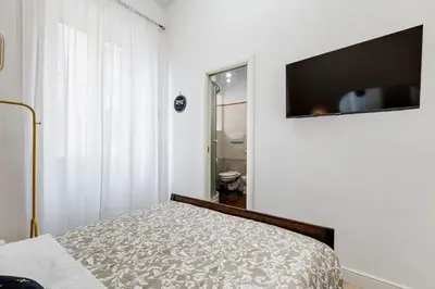 a bedroom with a bed and a flat screen tv at BDC - The Choice, your 2-Bdr apt in Vatican district in Rome