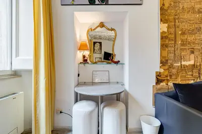 a small room with a table and a mirror at Trevi Art Suite in Rome