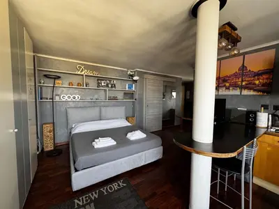 a bedroom with a bed and a table in a room at Casetta Fleming in Rome