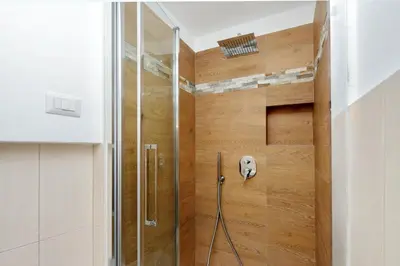 a shower with a glass door in a bathroom at Casetta Fleming in Rome