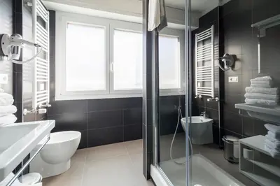 a bathroom with a shower and a toilet and a sink at Happy Holiday in Rome b&b in Rome