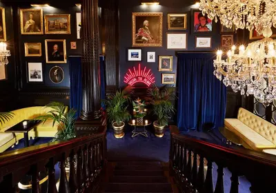 a living room with blue walls and a chandelier at Palazzo Dama - Hotel & SPA - Preferred Hotels & Resorts in Rome