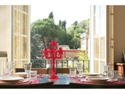 a living room with red chairs and a table at Apartment Margutta in Rome