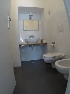 a bathroom with a sink and a toilet and a mirror at TuttoTondo Roma in Rome