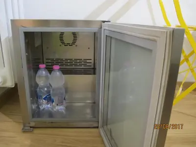 an open refrigerator with two bottles of water in it at TuttoTondo Roma in Rome
