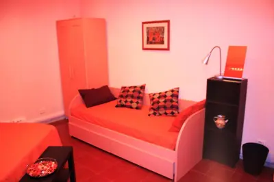 a room with a bed with pillows on it at Le Tre Sorelle B&b Garbatella in Rome