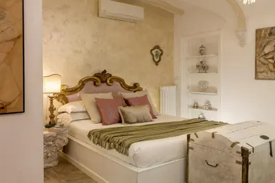 a bedroom with a large bed with colorful pillows at St.Peter's Mirror - Romantic View in Rome