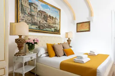 a bedroom with a bed and a painting on the wall at St.Peter's Mirror - Romantic View in Rome