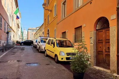 a yellow car parked on a street next to a building at Appartamento Sforza a Monti in Rome