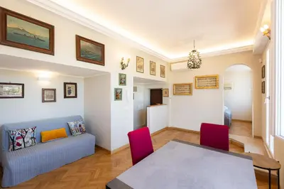 a living room with a table and a couch at Argentina Penthouse by Rental in Rome in Rome