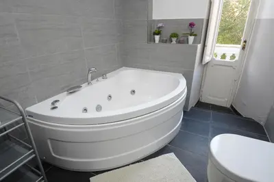 a white bath tub in a bathroom with a toilet at Casa Dania in Rome