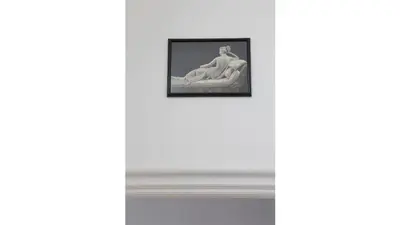 a picture of a woman sitting on a wall at Casa Dania in Rome
