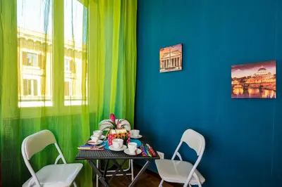 a table with chairs in a room with a blue wall at Da Augusto in Rome