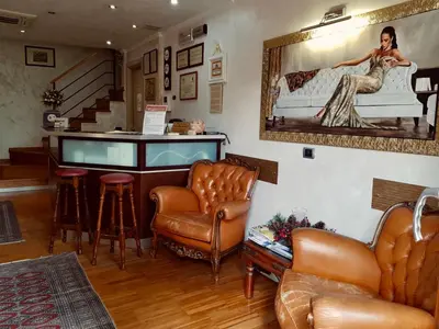 a living room with a bar with a couch and a mirror at Aurelia Garden Gold B&B in Rome