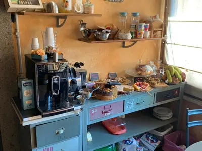 a table with a coffee maker on top of it at Aurelia Garden Gold B&B in Rome