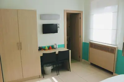 a room with a desk and a tv on the wall at Domus Helena in Rome