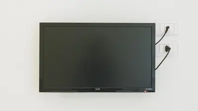 a flat screen tv with two cords plugged into an outlet at Domus Helena in Rome