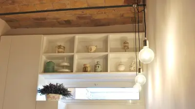 a room with white shelves with vases and lights at B&B Casa Angelini in Rome