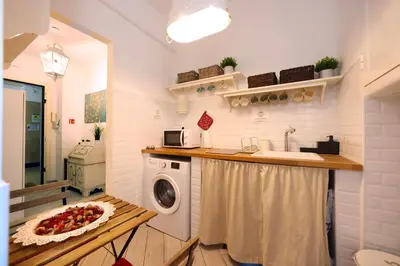 a kitchen with a sink and a washing machine at Sivory Rome in Rome