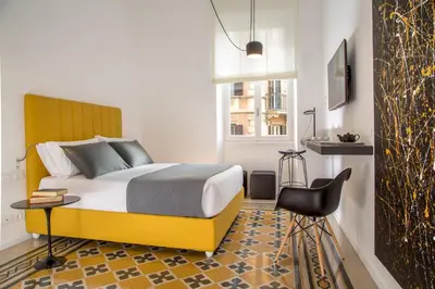 a bedroom with a bed and a table and a chair at Belli36rooms near Spanish step and Vatican City in Rome