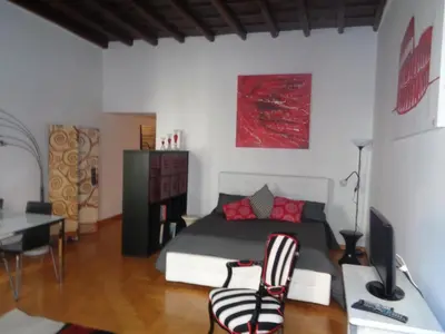 a bedroom with a bed and a desk with a computer at World Wide Bed Piazza del Popolo in Rome
