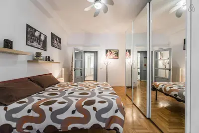 a bedroom with a large bed and a couch at Modern Living San Paolo - Vicino alla Metro in Rome