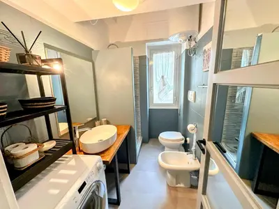 a bathroom with two sinks and a washing machine at Modern Living San Paolo - Vicino alla Metro in Rome