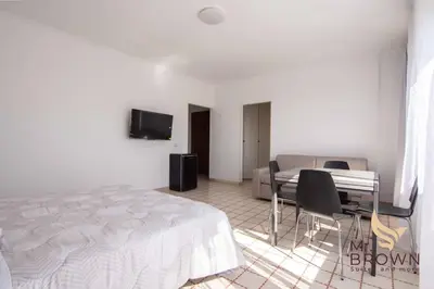 a bedroom with a bed and a table and chairs at Mr Brown Home and suites in Rome