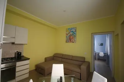 a kitchen and a living room with a couch and a table at Sweet Monte Verde in Rome